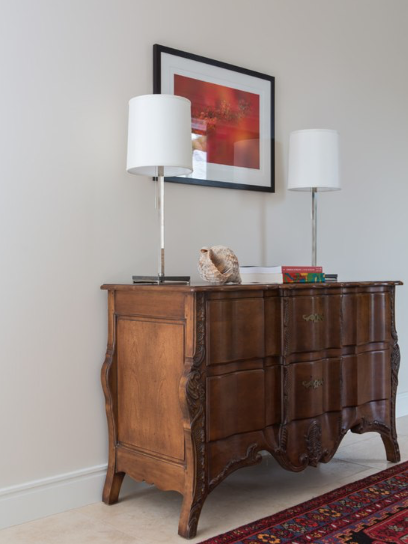 warm wooden furniture in entry way of california cool home in San Diego designed by celebrity designer Lori Dennis