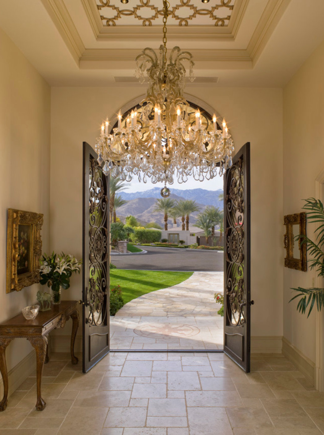 Keep this area welcoming and abstract-- we suggest saving any family photos or anything super personal for down the hall. That's a great way to keep an entry way formal, as well--like in this Palm Spring Home.