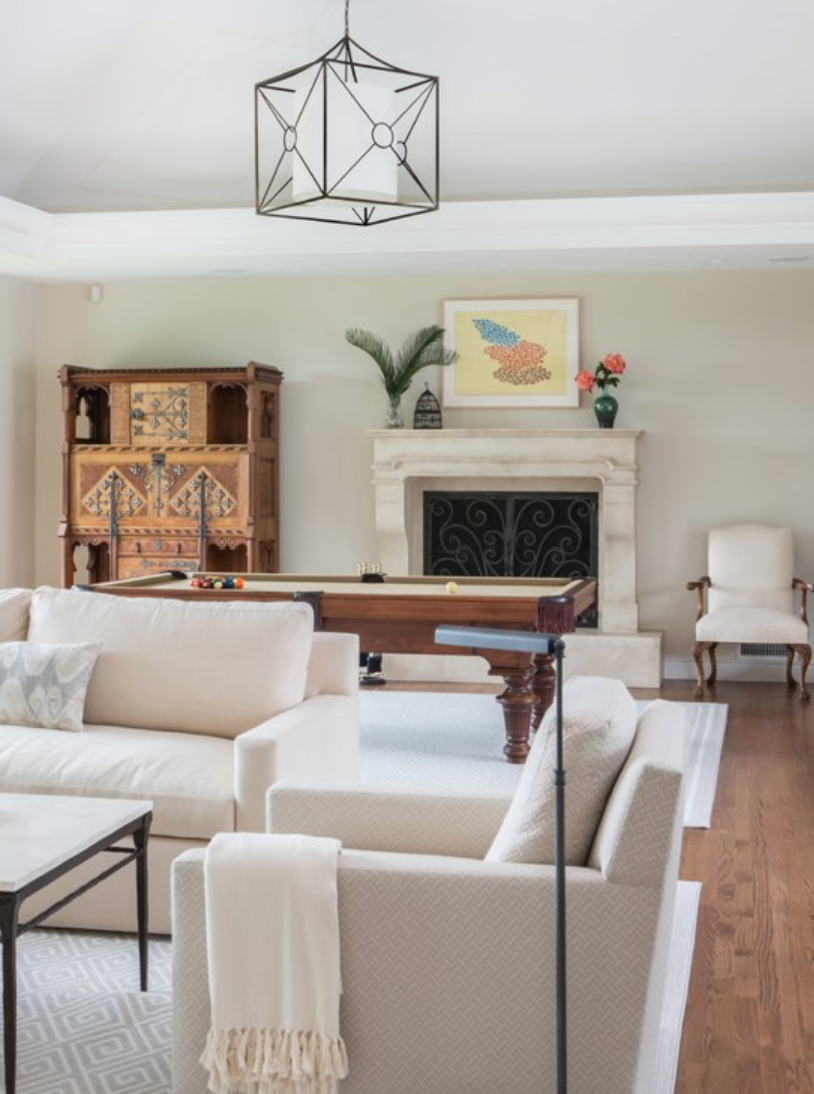 Emphasize warmth, elegance, and symmetry with obelisks and other architectural art objects. Fireplace mantles are also a great place to display objects collected from worldly travels, as they often add some texture to an otherwise more formal space, like this Lemon Ranch living room.