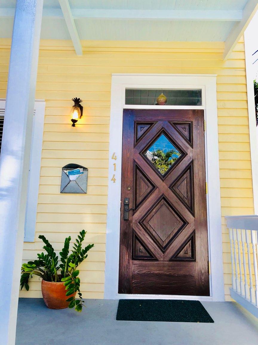 Natural Wood Front Door on Yellow House 