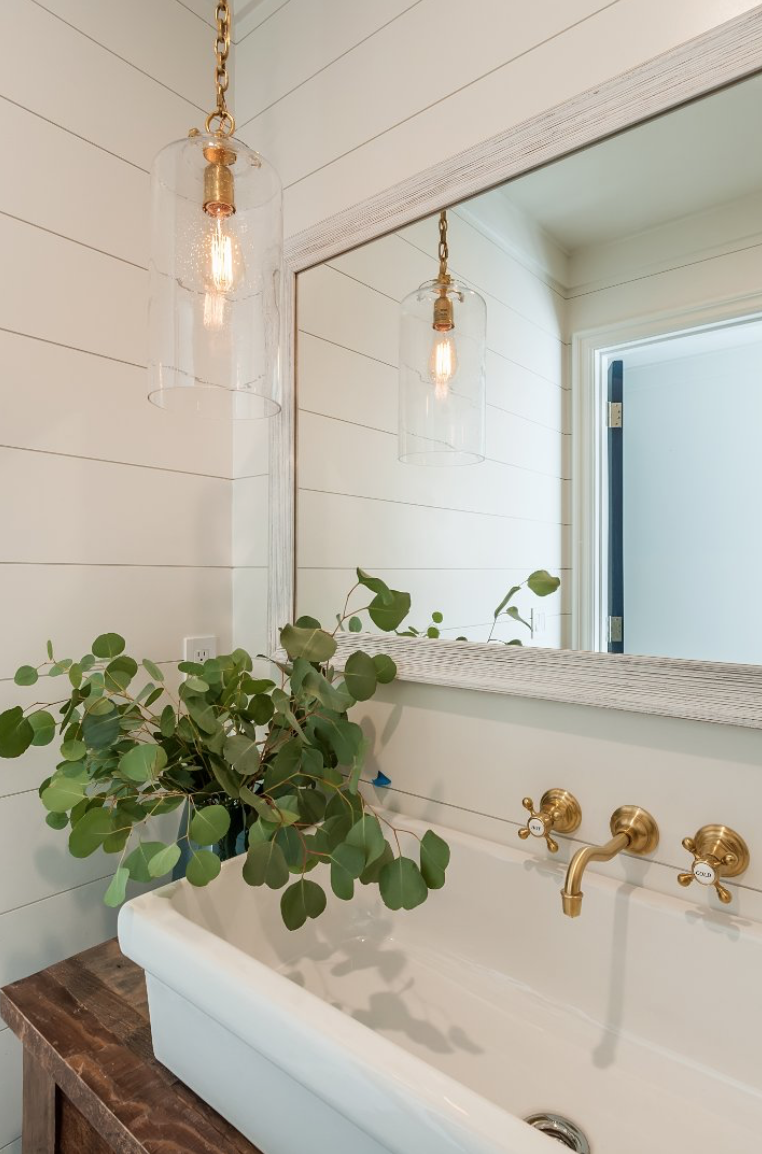 Farmhouse sinks with modern, trendy hardware in interesting finishes have become increasingly popular.