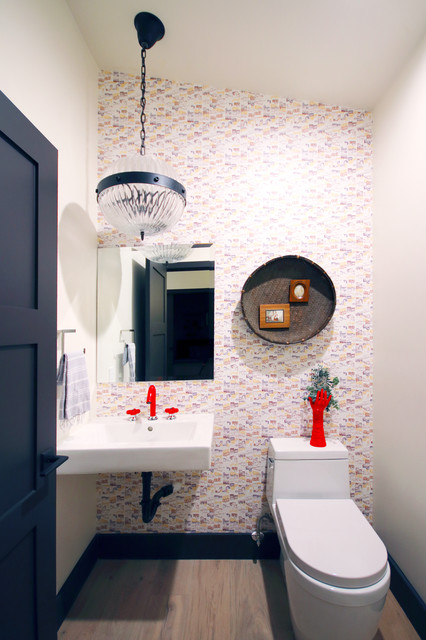 modern powder room with chandelier and red accents designed by Lori Dennis