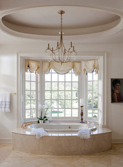 chandelier over bathtub traditional bathroom designed by Lori Dennis