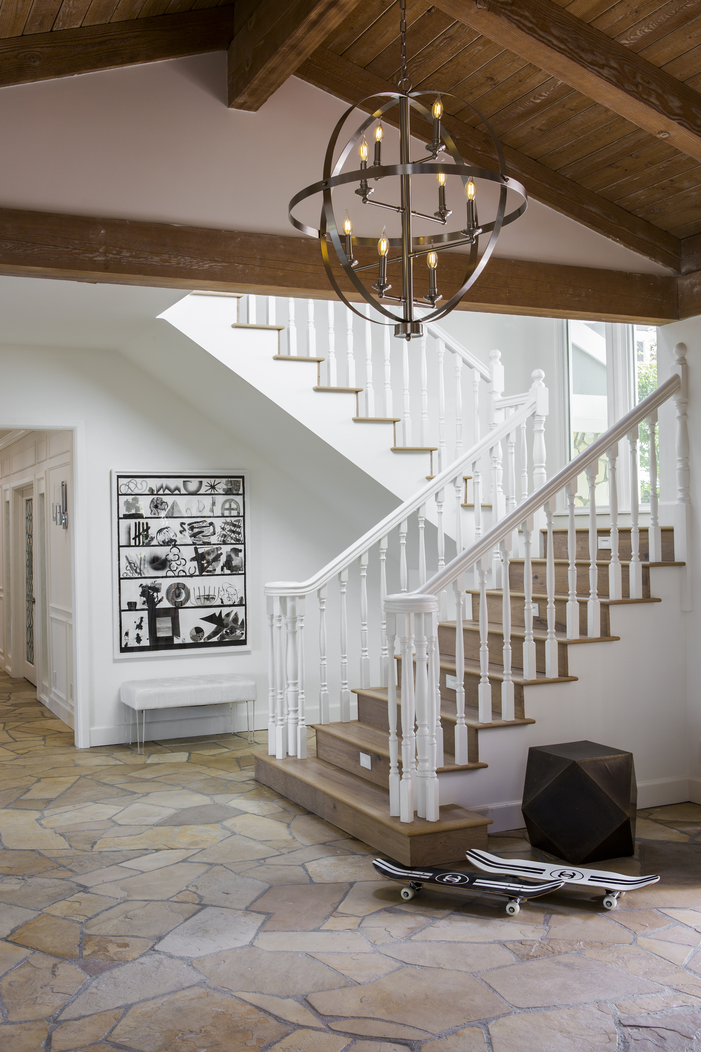 The entryway chandeliers are also from Lamps Plus: The Hudson Valley manufactured Bari chandelier in polished nickel was the perfect fixture to add some glamour to the California Ranch home.