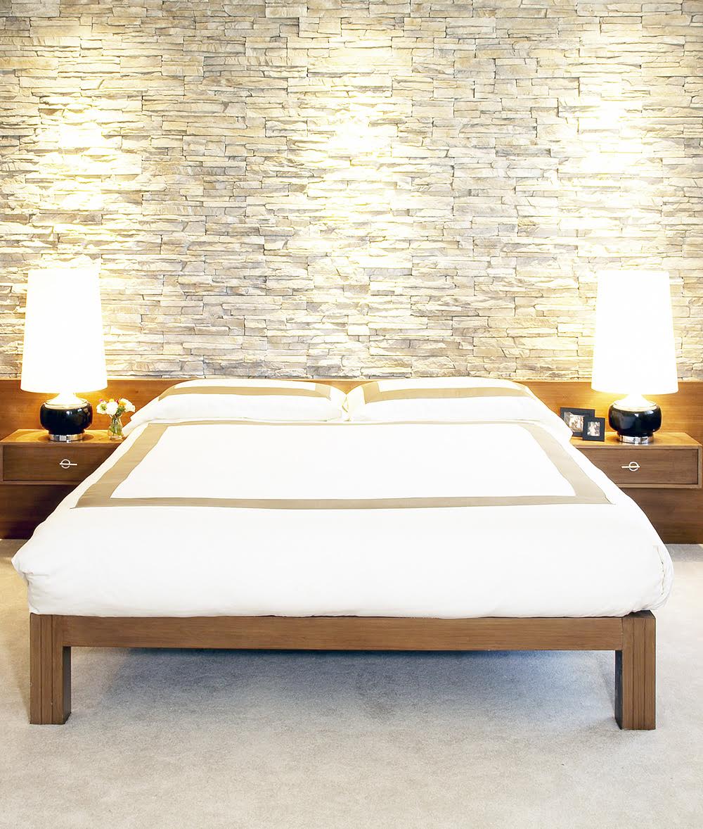 Stone veneer wall feature in Lake Tahoe mid century modern bedroom by interior designer Lori Dennis won green interior design award