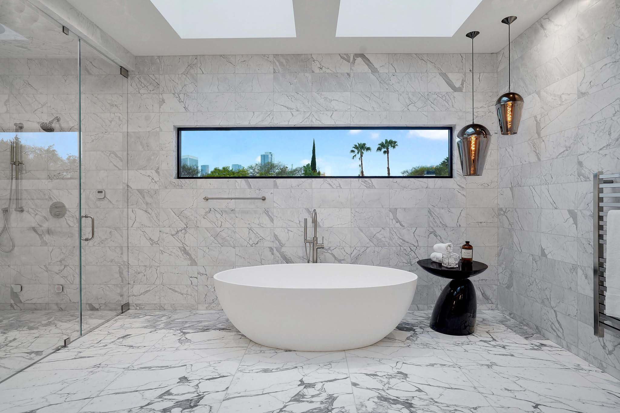 Modern Beverly Hills primary bathroom with freestanding tub designed by Lori Dennis Interior Design